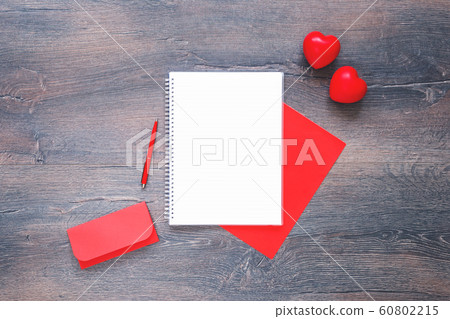 Two red hearts with envelope and notepad on wooden Two red hearts with envelope and notepad on wooden 60802215