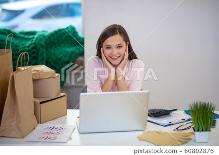 Happy nice young woman holding her cheeks Happy nice young woman holding her cheeks 60802876