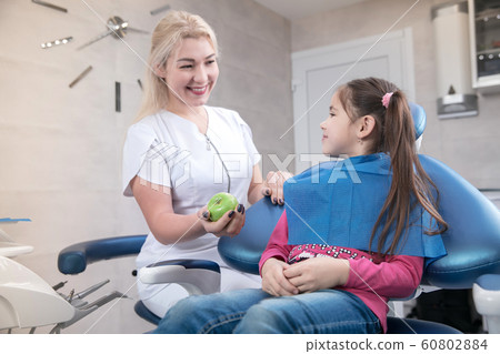 Young caucasian girl visiting dentist's office Young caucasian girl visiting dentist's office 60802884