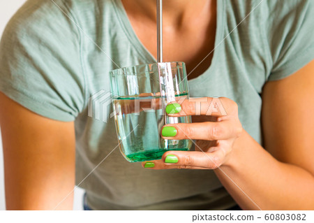 Girl drinks from reusable steel straw. Zero waste 60803082