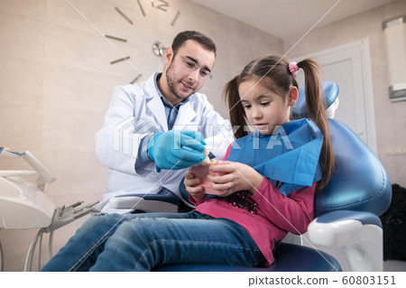 Young caucasian girl visiting dentist's office Young caucasian girl visiting dentist's office 60803151