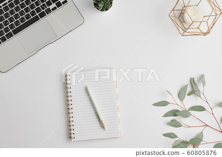 Notebook with pen, candle, domestic plant, branch with green leaves and laptop 60805876