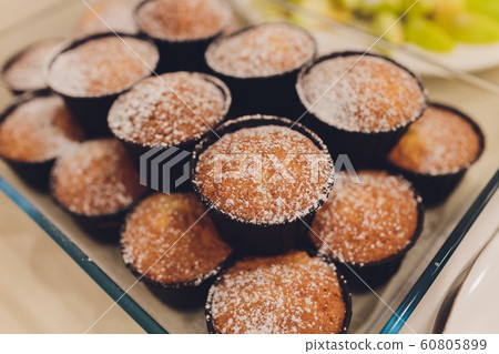 Many banana muffins. stack of banana muffins on a black plate closeup. Banana Cupcake Delicious Homemade on wood tray Freshly baked, sugary muffins. delicious mini cake flavor muffins for breakfast. Many banana muffins. stack of banana muffins on a black plate closeup. Banana Cupcake Delicious Homemade on wood tray Freshly baked, sugary muffins. delicious mini cake flavor muffins for breakfast. 60805899