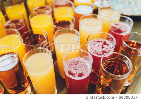 Glasses of fresh juice on an old wooden table. Glasses of fresh juice on an old wooden table. 60806017