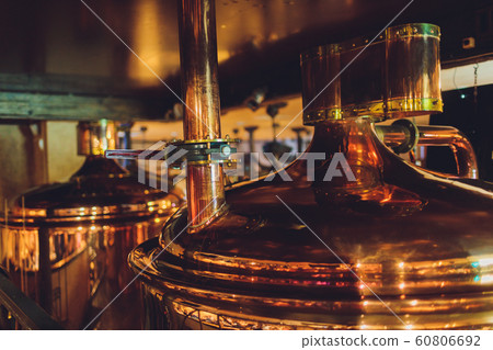 Craft beer brewing equipment in brewery Metal tanks, alcoholic drink production. Craft beer brewing equipment in brewery Metal tanks, alcoholic drink production. 60806692