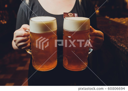Waiter serving glasses of cold beer on the tray. 60806694