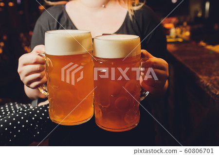 Waiter serving glasses of cold beer on the tray. 60806701