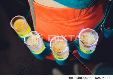 A yellow shot of tequila young woman in orange. A yellow shot of tequila young woman in orange. 60806788