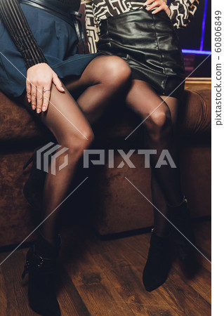 Beautiful female legs in black pantyhose in a restaurant. Beautiful female legs in black pantyhose in a restaurant. 60806849