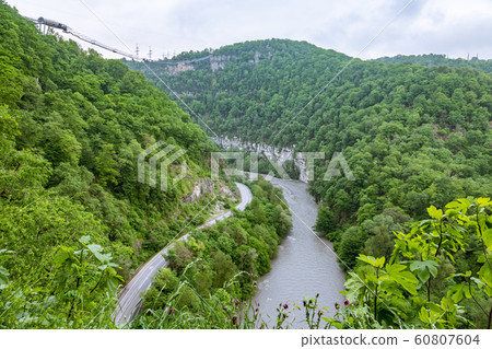 A gorge in the mountains with a suspension bridge A gorge in the mountains with a suspension bridge 60807604