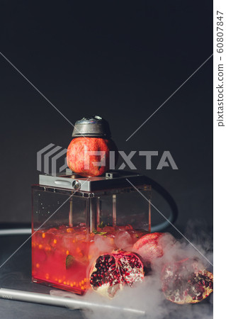 Exotic smoking shisha in east style with tobacco aroma of pomegranate.Fruit hookah. Exotic smoking shisha in east style with tobacco aroma of pomegranate.Fruit hookah. 60807847