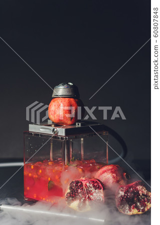Exotic smoking shisha in east style with tobacco aroma of pomegranate.Fruit hookah. Exotic smoking shisha in east style with tobacco aroma of pomegranate.Fruit hookah. 60807848