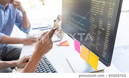 Pensive programmer working on on desktop pc Pensive programmer working on on desktop pc 60808768
