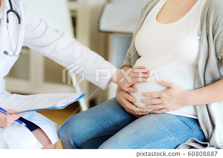 Gynecologist doctor accepts of a pregnant woman. 60808887