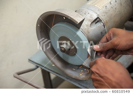 The skill operator use hand for regrinding . The skill operator use hand for regrinding . 60810549