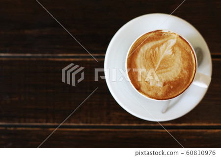 Cup of cappuccino or latte on wooden background. Coffee cup, top view. 60810976