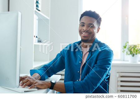 African designer working on computer African designer working on computer 60811700