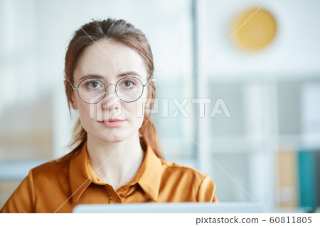 Young woman working at office Young woman working at office 60811805