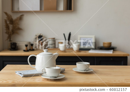 White tea set for tea drinking on served table in kitchen 60812157