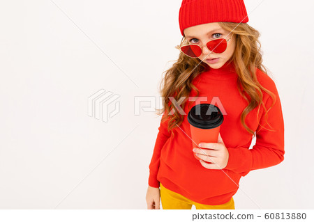 Happy teenager girl with red hair, red glasses smiles and drinks coffee isolated on white background Happy teenager girl with red hair, red glasses smiles and drinks coffee isolated on white background 60813880