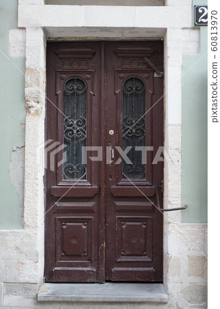 Vintage brown wooden door with forging elements. Vintage brown wooden door with forging elements. 60813970
