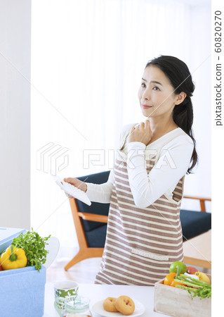 Middle woman worried with a calculator 60820270