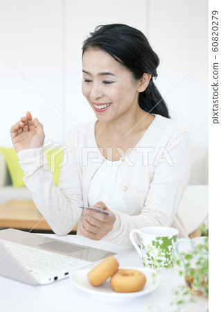 Middle women doing online shopping Middle women doing online shopping 60820279