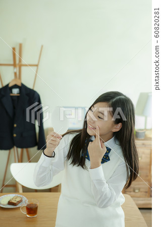 Female student with a hand mirror Female student with a hand mirror 60820281