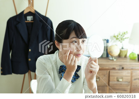 Female student with a hand mirror Female student with a hand mirror 60820318