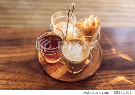 Vintage hot coffee set with soft boiled eggs and toasted sticks on wooden table in morning sunlight 60821101