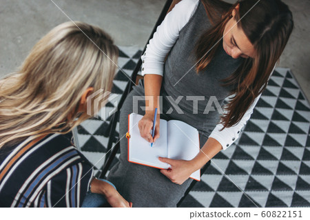 Young successful women colleagues discuss joint project Young successful women colleagues discuss joint project 60822151
