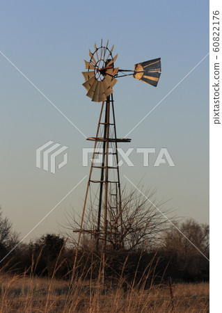 Windmill at Sunset with tree's and Sky. 60822176