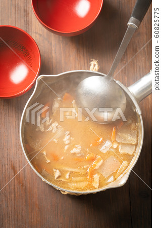 Pork juice in a pot 60825775