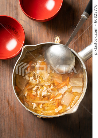 Pork juice in a pot 60825776
