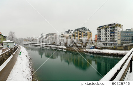 Panorama of the River Drau crossing the town of Villach in Austria in a winter day during a snow storm Panorama of the River Drau crossing the town of Villach in Austria in a winter day during a snow storm 60826746