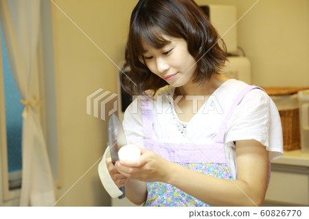 Woman peeling radish 60826770