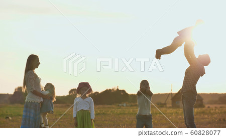 Happy parents of 4 children toss up their children. Happy parents of 4 children toss up their children. 60828077