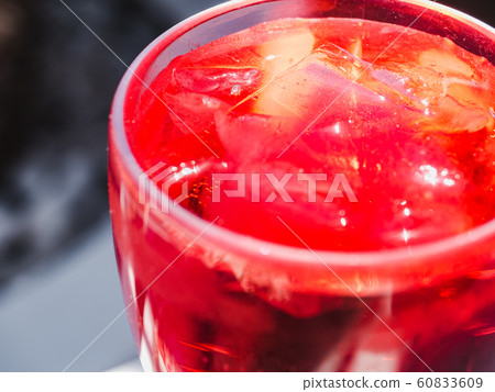 Beautiful glass with a pink cocktail and ice Beautiful glass with a pink cocktail and ice 60833609