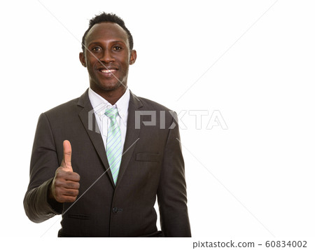 Young happy black African businessman smiling and giving thumb u Young happy black African businessman smiling and giving thumb u 60834002
