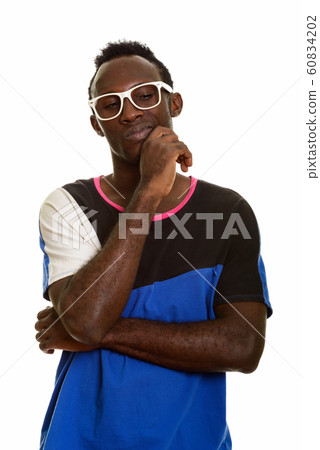 Young worried African man thinking while looking down Young worried African man thinking while looking down 60834202