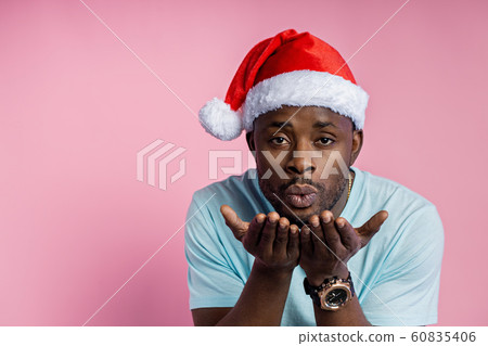 African american man wearing Santa hat 60835406