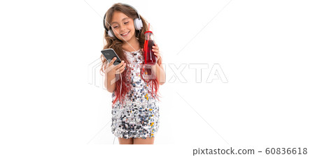 Little pretty caucasian girl listen to music with big earphones and smiles, pa isolated on white Little pretty caucasian girl listen to music with big earphones and smiles, pa isolated on white 60836618