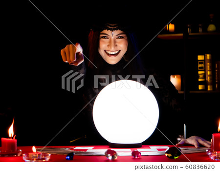 The witch is casting a spell to perform a ritual. The witch is casting a spell to perform a ritual. 60836620