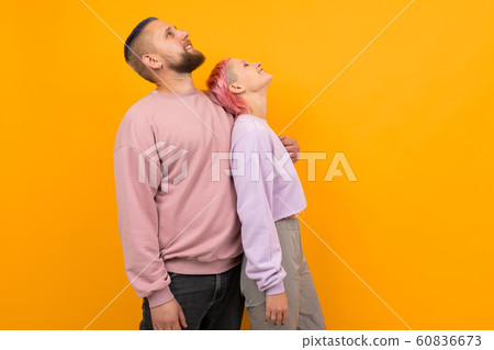 Unusual pretty woman with short pink hair and tattoo enjoys life with her boyfriend isolated on Unusual pretty woman with short pink hair and tattoo enjoys life with her boyfriend isolated on 60836673