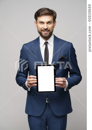 Young Businessman presenting digital tablet pc pad with blank screen Young Businessman presenting digital tablet pc pad with blank screen 60838689