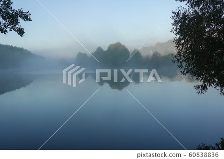 Early morning on the lake. Fog above the water. 60838836
