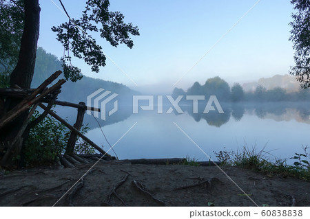 Early morning on the lake. Fog above the water. 60838838