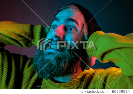 Caucasian man's portrait isolated on gradient studio background in neon light Caucasian man's portrait isolated on gradient studio background in neon light 60839984