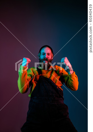 Caucasian man's portrait isolated on gradient studio background in neon light Caucasian man's portrait isolated on gradient studio background in neon light 60840439