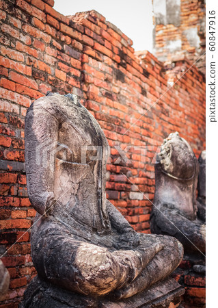 Old headless broken buddha statue at Ayutthaya 60847916